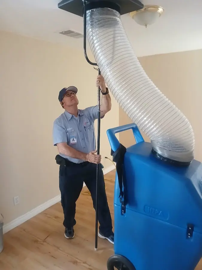 Furnace Tune-Up technician using HEPA equipment in Carmel
